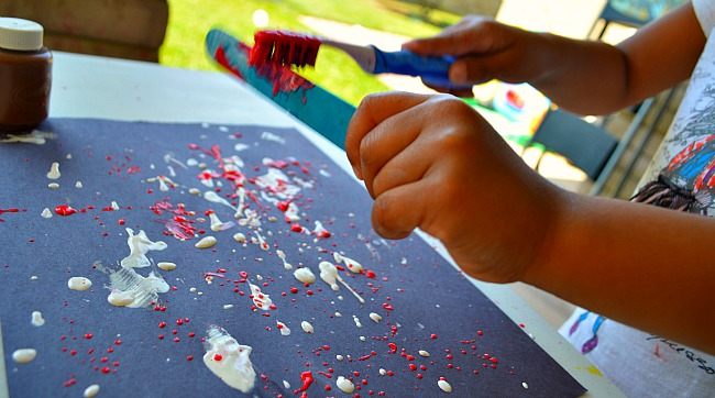 use popsicle to splatter paint
