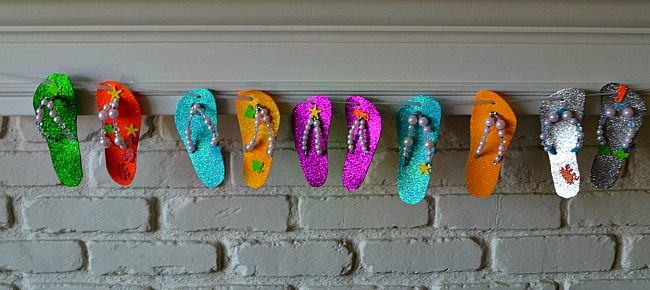 summer themed kids keepsakes hanging by fireplace
