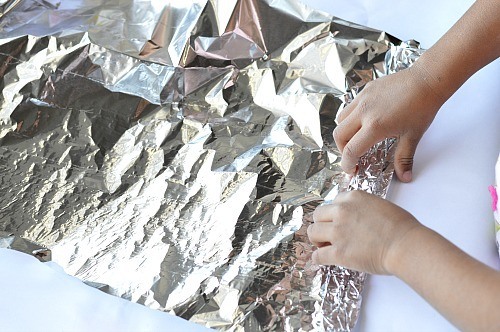 rolling the foil for rainbow craft for kids